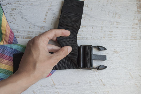 Fold down the strap at right angle towards the click.